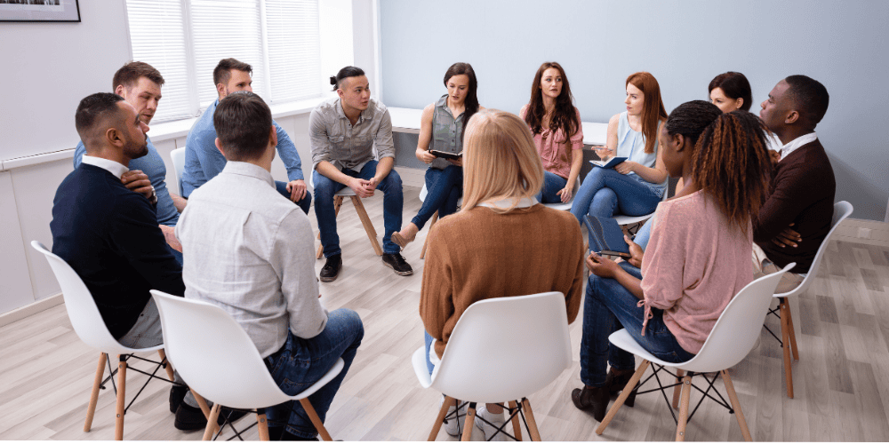 Midlife Transitions support group in session, diverse individuals in a circle.